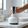 Electric Massage Device with Digital Controls on a marble countertop with hand adjusting the settings.