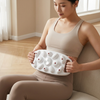 Large Area Vibrating Abdominal Massage Device being used by a woman sitting on a chair for abdominal massage.
