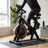Indoor Spin Bike with Digital Display & Flywheel in a home setting equipped for a stable workout experience.