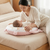 Mom and baby using Long Plush Baby Pillow with Printed Design for comfort and support during playtime on the bed.