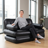 Person relaxing on a 5-in-1 Inflatable Air Couch, showcasing its versatility as a chair or bed.