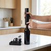Electric Wine Opener Set with Bottle Accessories in a kitchen, featuring an opener and wine accessories on a compact base.