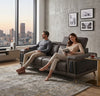 Couple relaxing on a Contemporary Modular Lounge Sofa Set, enjoying a stylish living space with city view.