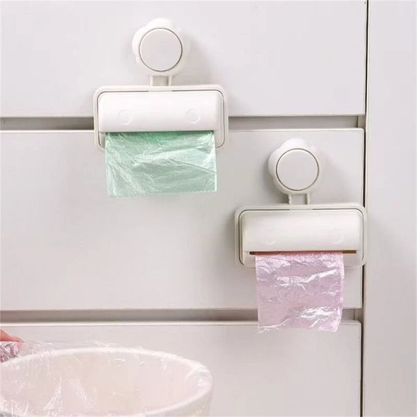 Kitchen Trash Bag Stand with Adhesive Backing holding green and pink bags on a cabinet door.