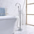 Stylish Free Standing Chrome Bath Mixer next to freestanding tub, enhancing modern bathroom decor.