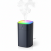 Mini Humidifier with RGB Light releasing mist and glowing with colorful ambient lighting.