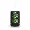 Compact Home & Office Air Humidifier with intricate design and green glow, emitting mist for improved air quality.