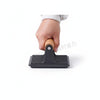 Hand holding a Ridged Grill Press with Wooden Handle for even cooking while grilling or pan-frying.