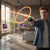 A young boy using a Kids Spider Web Shooter Wrist Launcher Toy Glove Set in a modern living room.