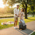 Couple using a Rolling Trolley Bag with Front Pocket & Mesh Panels in a park during sunset.