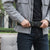 Person adjusting a Utility Tactical-Style Belt for a secure fit during outdoor activities.