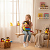 Girl hugging a colorful Plush Parrot Toy while sitting on a swing in a cozy room.