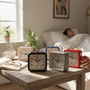 Wake Mate Modern Kids Bedside Alarm Clock collection on a table, with a person relaxing in bed in the background.