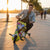 A rider enjoying the 36V 3-Wheel Electric Drifting Trike during sunset on a city path.