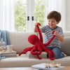 A child plays with a Realistic Octopus Plush Toy, enjoying its lifelike details and vibrant color in a cozy living room setting.