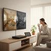 Woman enjoying a beverage while watching a 5-in-1 Digital Video Recorder connected to a large TV displaying video footage.