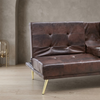 Modern Tufted Faux Leather Sleeper Couch with tufted design and gold legs in a modern living space.